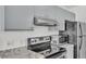 Kitchen boasts stainless steel appliances and gray cabinets at 6111 Morningview Dr, Lakeland, FL 33813