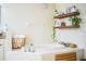 Relaxing bathroom with a large garden tub, double sinks, and floating shelves at 6358 Alamanda Hills Dr, Lakeland, FL 33813