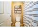 Simple bathroom with toilet and shower, updated shelving at 6358 Alamanda Hills Dr, Lakeland, FL 33813