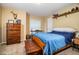 Cozy bedroom with wooden bed frame and dresser, offering ample space and natural light at 6358 Alamanda Hills Dr, Lakeland, FL 33813