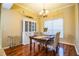 Bright dining room with wood floors, chandelier, and a farmhouse style hutch at 6358 Alamanda Hills Dr, Lakeland, FL 33813