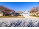 Single-story home with gray exterior, two-car garage, and landscaping at 6358 Alamanda Hills Dr, Lakeland, FL 33813