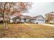 Ranch-style home with gray siding, stone accents, and mature trees at 6358 Alamanda Hills Dr, Lakeland, FL 33813