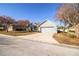 Single-story home with gray exterior, two-car garage, and landscaping at 6358 Alamanda Hills Dr, Lakeland, FL 33813