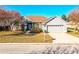 Single-story home with gray siding, stone accents, and a two-car garage at 6358 Alamanda Hills Dr, Lakeland, FL 33813