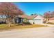 Single-story house with gray siding, two-car garage, and mature trees at 6358 Alamanda Hills Dr, Lakeland, FL 33813