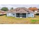 House back view with screened porch and fenced yard at 6358 Alamanda Hills Dr, Lakeland, FL 33813