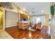 Spacious living area featuring hardwood floors, a rustic accent wall, and comfy furniture at 6358 Alamanda Hills Dr, Lakeland, FL 33813