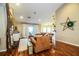 Living room with hardwood floors, a rustic wooden wall, and leather couches at 6358 Alamanda Hills Dr, Lakeland, FL 33813