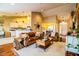 Bright living room features leather sofas, a coffee table, and hardwood floors at 6358 Alamanda Hills Dr, Lakeland, FL 33813