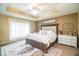 Spacious main bedroom with king-size bed, cozy rug, and plenty of natural light at 6358 Alamanda Hills Dr, Lakeland, FL 33813