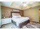 Main bedroom with king-size bed, ceiling fan, and decorative wall accents at 6358 Alamanda Hills Dr, Lakeland, FL 33813