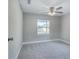 Bright bedroom with neutral carpeting, ceiling fan, and window with natural light at 638 W Thomas St, Lakeland, FL 33805