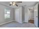 Bright bedroom with carpet, double closet, and ceiling fan at 638 W Thomas St, Lakeland, FL 33805