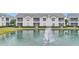 Rear view of townhome overlooking pond and fountain at 649 Grasslands Village Cir, Lakeland, FL 33803