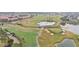 Golf course community with various homes and water features at 649 Grasslands Village Cir, Lakeland, FL 33803