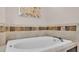 Oval bathtub with stone tile accents in the bathroom at 649 Grasslands Village Cir, Lakeland, FL 33803