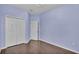 Light lavender bedroom with wood flooring and closet at 649 Grasslands Village Cir, Lakeland, FL 33803