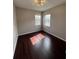 Bedroom featuring hardwood flooring and large windows at 649 Grasslands Village Cir, Lakeland, FL 33803