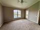 Bright bedroom with water view, carpet flooring and access to balcony at 649 Grasslands Village Cir, Lakeland, FL 33803