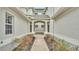 Arched entryway with pathway leading to front door at 649 Grasslands Village Cir, Lakeland, FL 33803