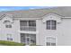 Condo building exterior featuring balconies and screened porch at 649 Grasslands Village Cir, Lakeland, FL 33803