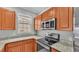 Modern kitchen with stainless steel appliances and granite countertops at 649 Grasslands Village Cir, Lakeland, FL 33803