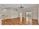 Spacious living room with hardwood floors and balcony access at 649 Grasslands Village Cir, Lakeland, FL 33803