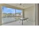 Screened balcony overlooking a pond with glass table at 649 Grasslands Village Cir, Lakeland, FL 33803