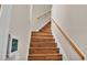 Wooden staircase with wooden railing and wall-mounted panel at 649 Grasslands Village Cir, Lakeland, FL 33803