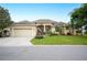 Beautiful one-story home with a two-car garage and manicured lawn at 6550 Evergreen Park Dr, Lakeland, FL 33813