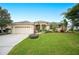 One-story house with a large front yard and palm trees at 6550 Evergreen Park Dr, Lakeland, FL 33813