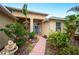 Welcoming entryway with a blue door and colorful landscaping at 6550 Evergreen Park Dr, Lakeland, FL 33813