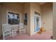 Front porch with rocking chairs and a blue front door at 6550 Evergreen Park Dr, Lakeland, FL 33813