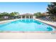 Community pool with lounge chairs and a pool house at 6550 Evergreen Park Dr, Lakeland, FL 33813