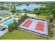 Aerial view of community amenities including tennis courts, pool, and clubhouse at 7068 Island Lake Ln, Lakeland, FL 33813