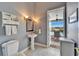 Powder room with pedestal sink, and views of the pool area at 7068 Island Lake Ln, Lakeland, FL 33813