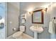 Guest bathroom with pedestal sink and toilet at 7068 Island Lake Ln, Lakeland, FL 33813