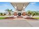 Brick clubhouse entrance with palm trees and golf cart at 7068 Island Lake Ln, Lakeland, FL 33813