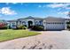 Gray two-story house with a three-car garage and landscaped yard at 7068 Island Lake Ln, Lakeland, FL 33813