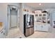 Kitchen with stainless steel refrigerator and white cabinetry at 7068 Island Lake Ln, Lakeland, FL 33813