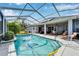 Inviting pool area with covered patio, lounge chairs, and solar panels at 7068 Island Lake Ln, Lakeland, FL 33813