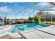 Enclosed pool and patio area with lounge chairs at 7068 Island Lake Ln, Lakeland, FL 33813