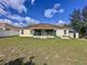 Spacious backyard with screened patio and large grassy area at 8 Sawfish Ln, Kissimmee, FL 34759