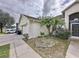 Home's exterior showcasing a side view of garage and landscaping at 8 Sawfish Ln, Kissimmee, FL 34759