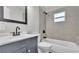 Modern bathroom with gray tile and a white bathtub at 865 S 9Th Ave, Bartow, FL 33830