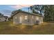 Newly painted light beige house with a spacious yard at dusk at 865 S 9Th Ave, Bartow, FL 33830