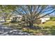 Property features large tree and driveway at 875 Hanover Way, Lakeland, FL 33813