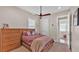 Cozy bedroom with wooden furniture and a ceiling fan at 875 Hanover Way, Lakeland, FL 33813