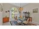 Elegant dining room with a glass table and chandelier at 875 Hanover Way, Lakeland, FL 33813